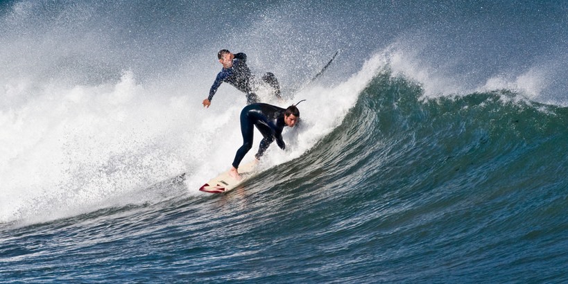 Men surfing catching waves