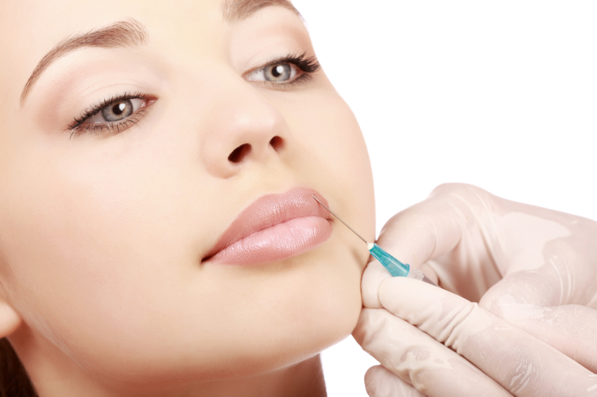 Woman with a syringe injected unto her mouth